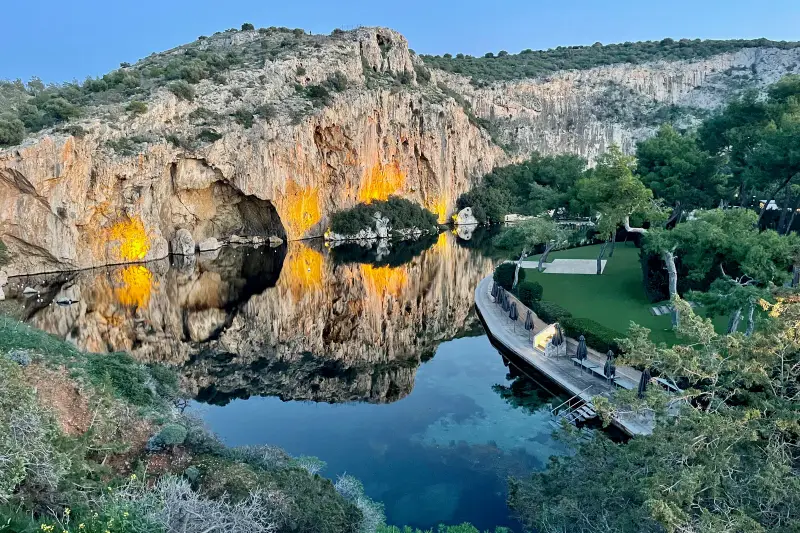 The thermal water of Lake Vouliagmeni beneath its limestone cliff
